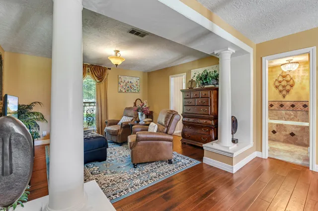 a living room with furniture and wooden floor