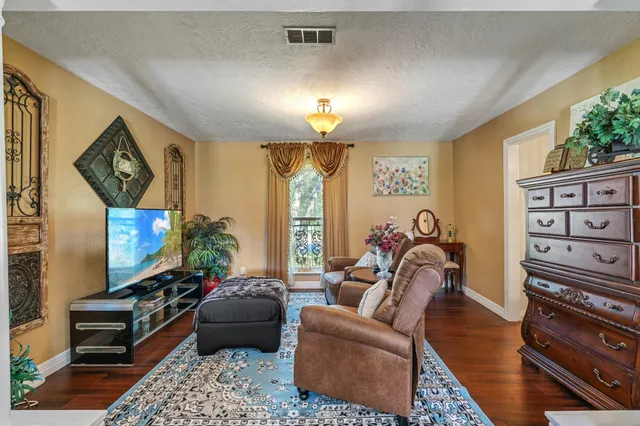 a living room with furniture a rug and a large window