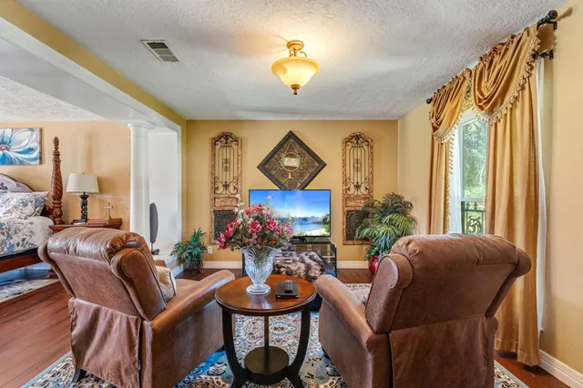 a living room with furniture a chandelier and a window