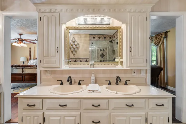 a bathroom with a sink vanity and a mirror