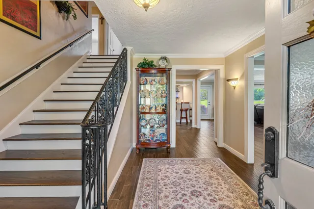 a view of an entryway with wooden floor