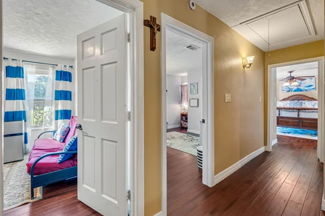 a view of a room with wooden floor and furniture