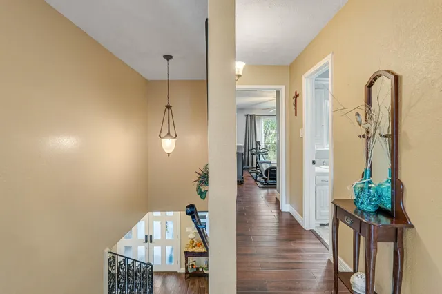 a view of a hallway view with wooden floor and staircase