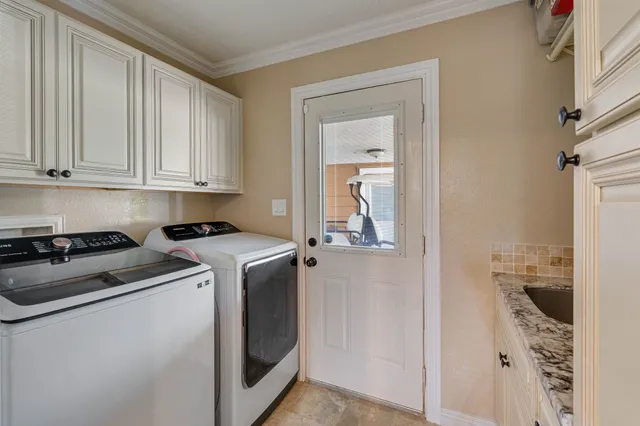 a utility room with closet dryer and washer