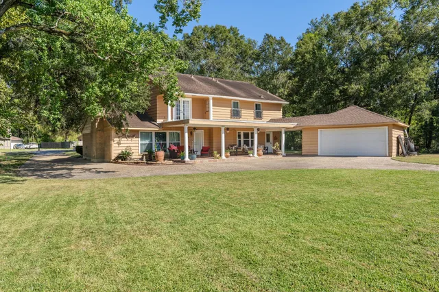 a front view of a house with a garden