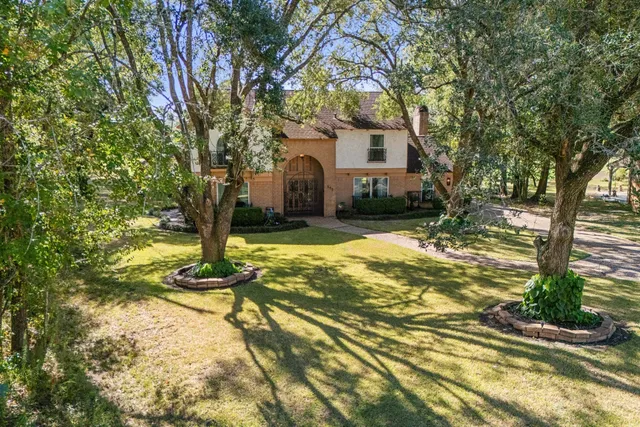 a view of a house with a yard covered with snow