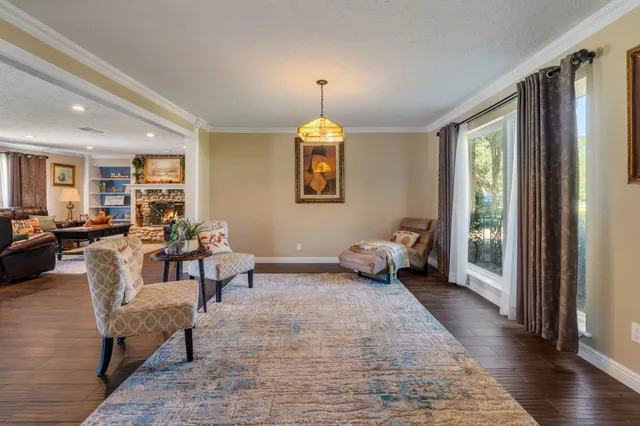 a living room with furniture and a chandelier