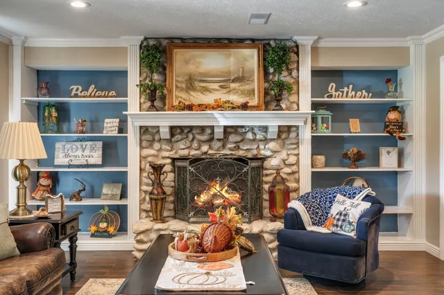a living room with lots of furniture and a book shelf