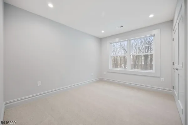 a view of a hallway with wooden floor and entryway