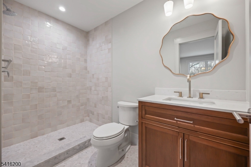 1209 Littleton Road, Unit D Morris Plains, NJ 07950 - Photo 18 of 23 a bathroom with a sink a toilet and shower