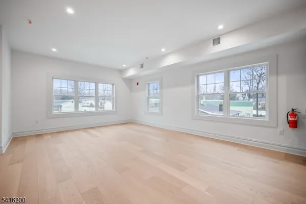 an empty room with windows and entrance