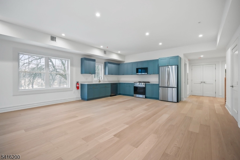 1209 Littleton Road, Unit D Morris Plains, NJ 07950 - Photo 7 of 23 a view of kitchen with stainless steel appliances kitchen island wooden floor and window