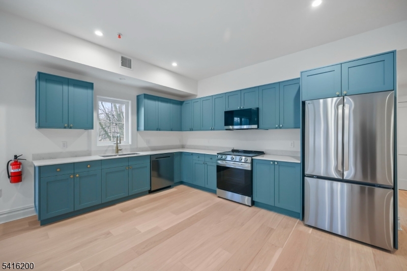 1209 Littleton Road, Unit D Morris Plains, NJ 07950 - Photo 8 of 23 a kitchen with granite countertop a refrigerator and a sink