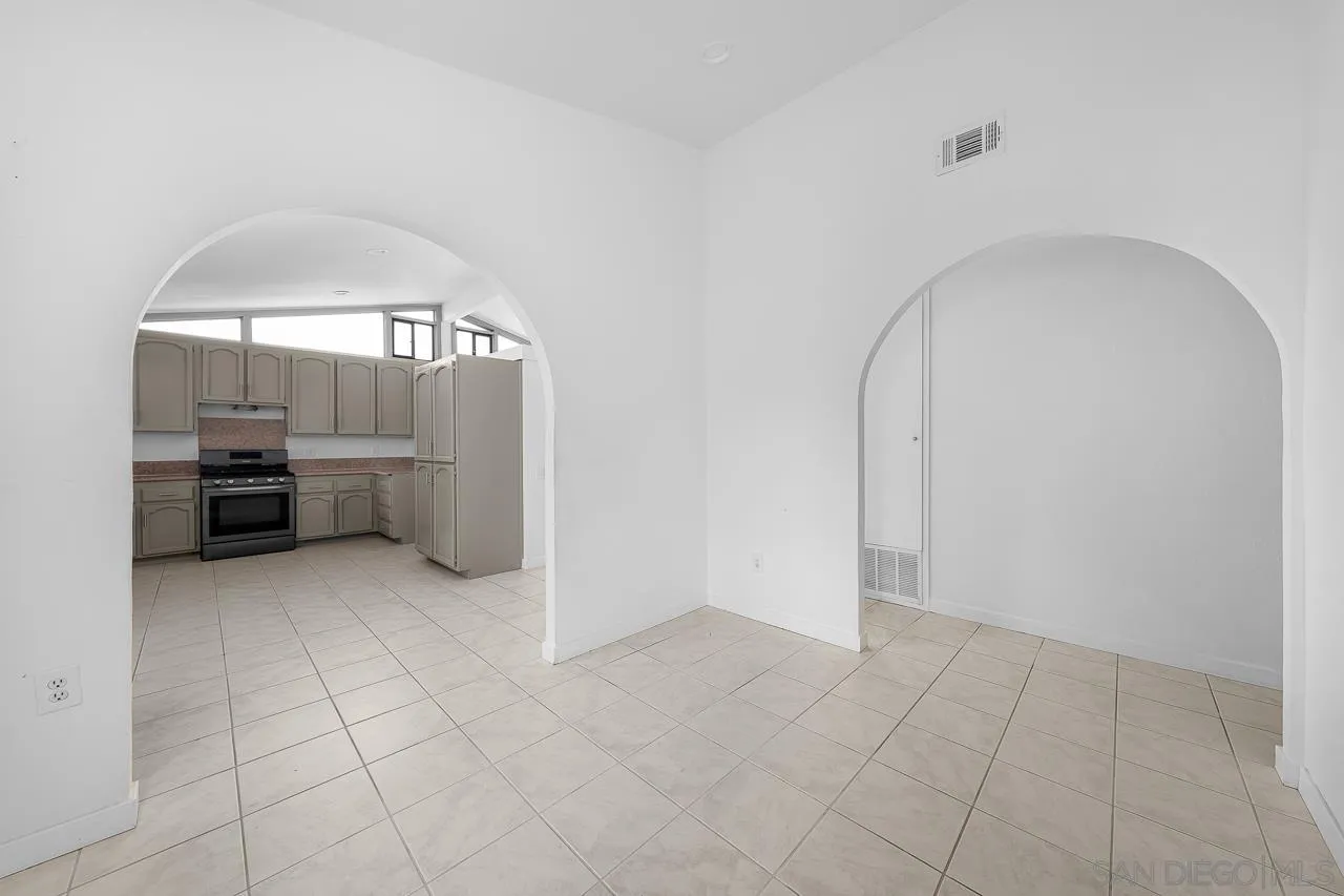 9927 Sadie Street Santee, CA 92071 - Photo 13 of 29 an empty room with fireplace and windows