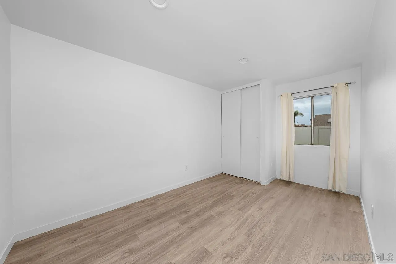 9927 Sadie Street Santee, CA 92071 - Photo 19 of 29 a view of an empty room with wooden floor and closet