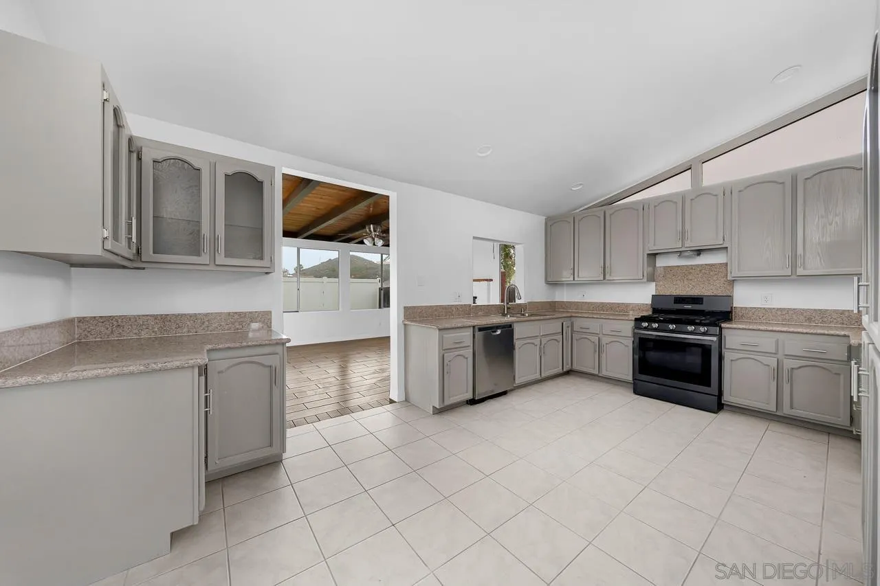 9927 Sadie Street Santee, CA 92071 - Photo 8 of 29 a kitchen with stainless steel appliances granite countertop a sink and cabinets