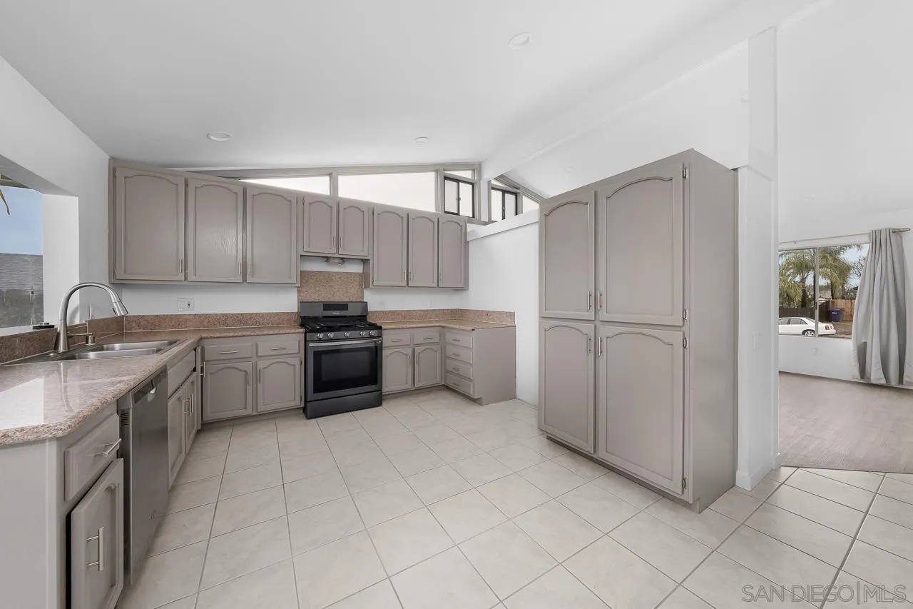 9927 Sadie Street Santee, CA 92071 - Photo 9 of 29 a kitchen with a sink cabinets and appliances