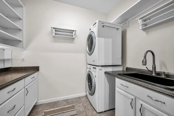 a utility room with sink dryer and washer