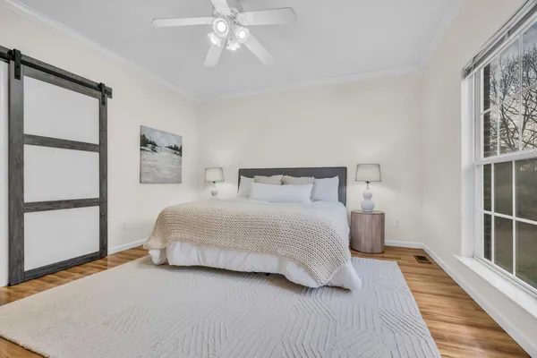 a bedroom with a bed and a window