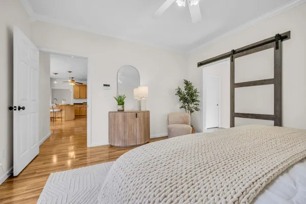 a bedroom with a large bed and a chandelier