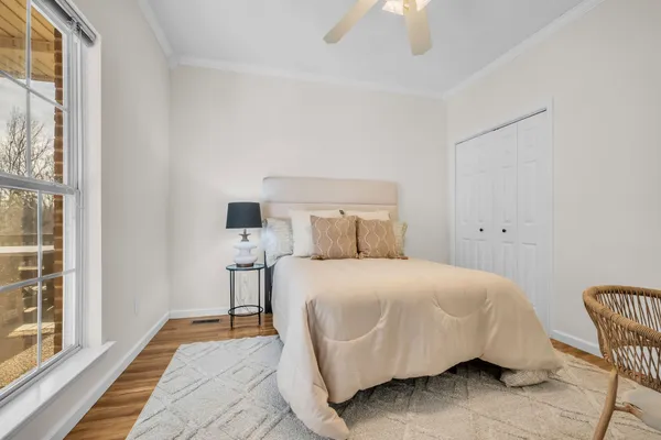 a bedroom with a bed and a window