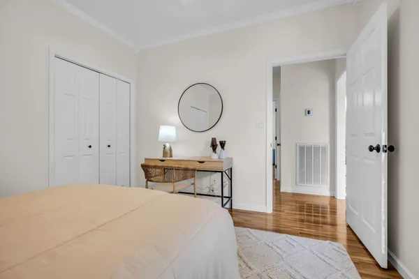 a bedroom with a bed and a chandelier