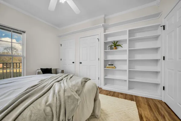 a bed sitting in a bedroom next to a window