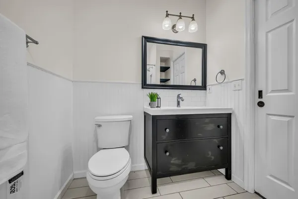 a bathroom with a toilet sink and mirror