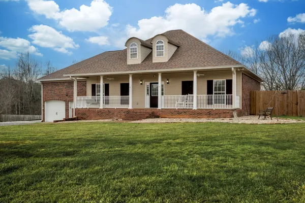 a view of a house with a backyard