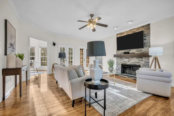 a living room with furniture a fireplace and a flat screen tv