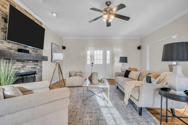 a living room with furniture a fireplace and a flat screen tv