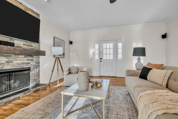 a living room with furniture a flat screen tv and a fireplace