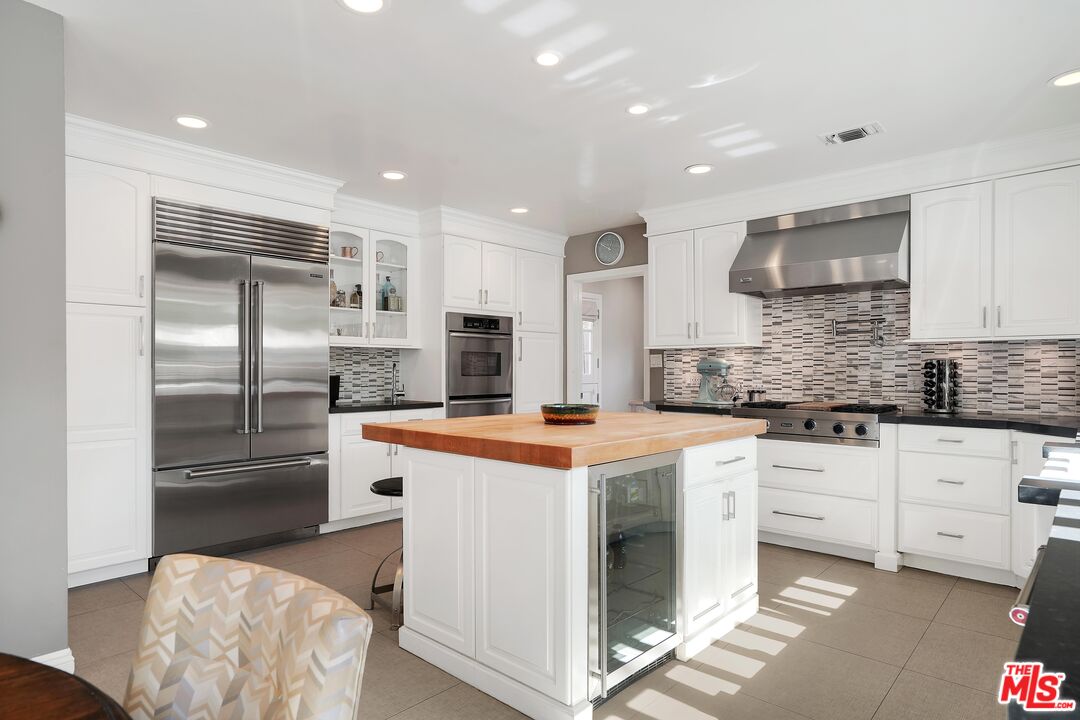 16722 Adlon Road Encino, CA 91436 - Photo 12 of 36 a kitchen with stainless steel appliances granite countertop a refrigerator and a stove top oven