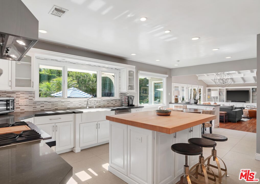 16722 Adlon Road Encino, CA 91436 - Photo 13 of 36 a kitchen with a stove a sink and a refrigerator