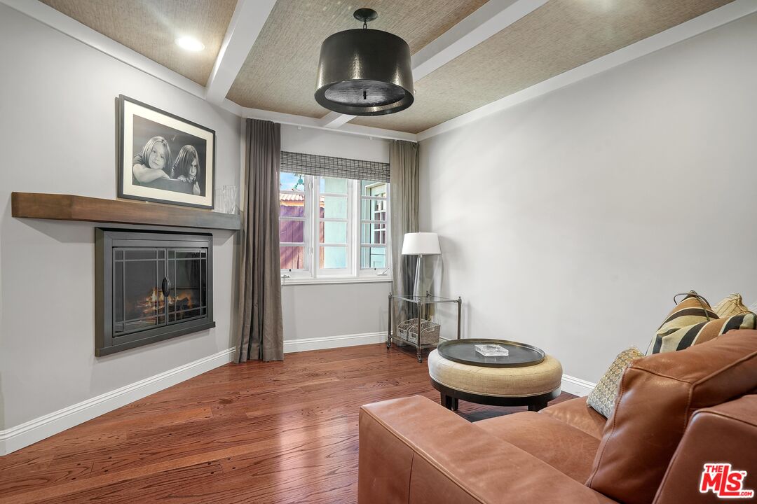 16722 Adlon Road Encino, CA 91436 - Photo 23 of 36 a living room with furniture and a fireplace