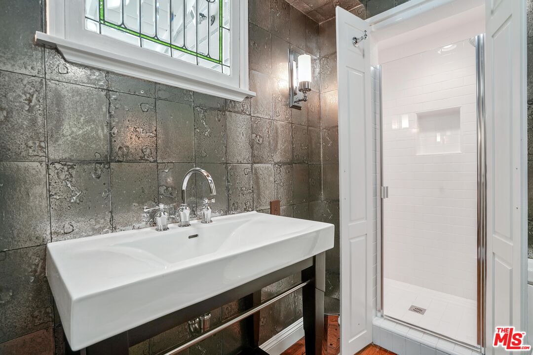 16722 Adlon Road Encino, CA 91436 - Photo 24 of 36 a bathroom with a sink and a mirror