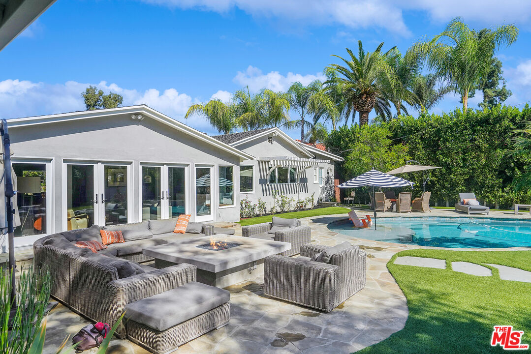 16722 Adlon Road Encino, CA 91436 - Photo 26 of 36 a view of a house with swimming pool and sitting area