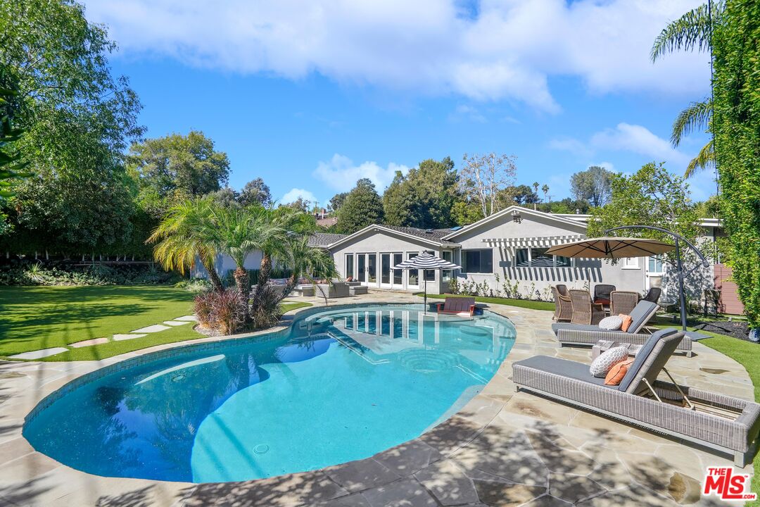 16722 Adlon Road Encino, CA 91436 - Photo 27 of 36 a view of a house with swimming pool and sitting area