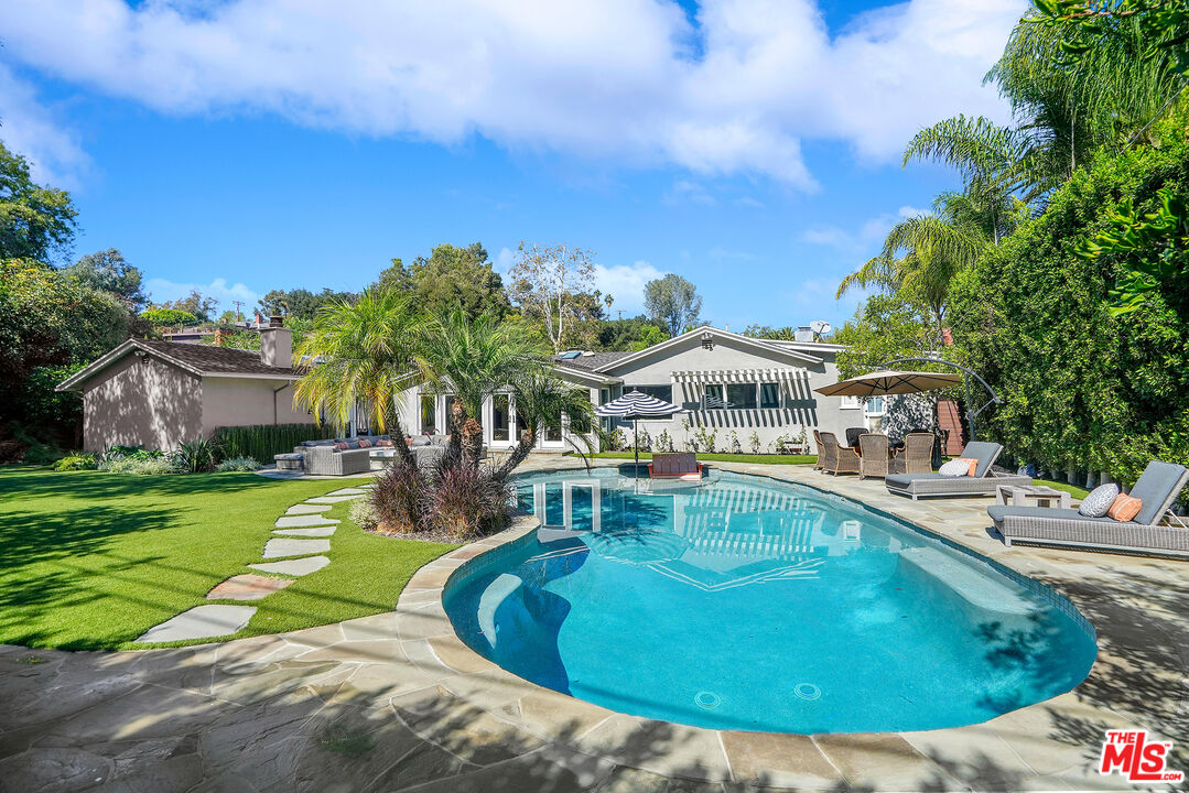 16722 Adlon Road Encino, CA 91436 - Photo 28 of 36 a view of a swimming pool with a garden