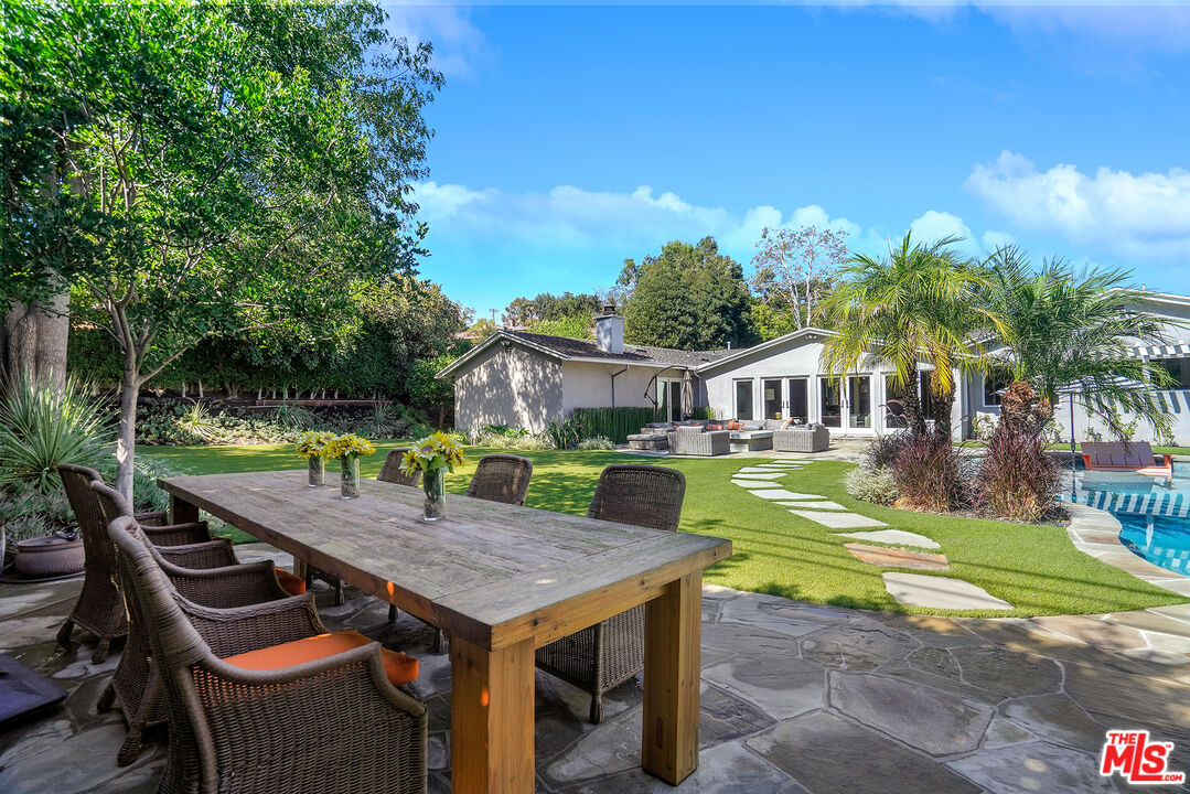 16722 Adlon Road Encino, CA 91436 - Photo 30 of 36 a view of a house with a swimming pool and sitting area