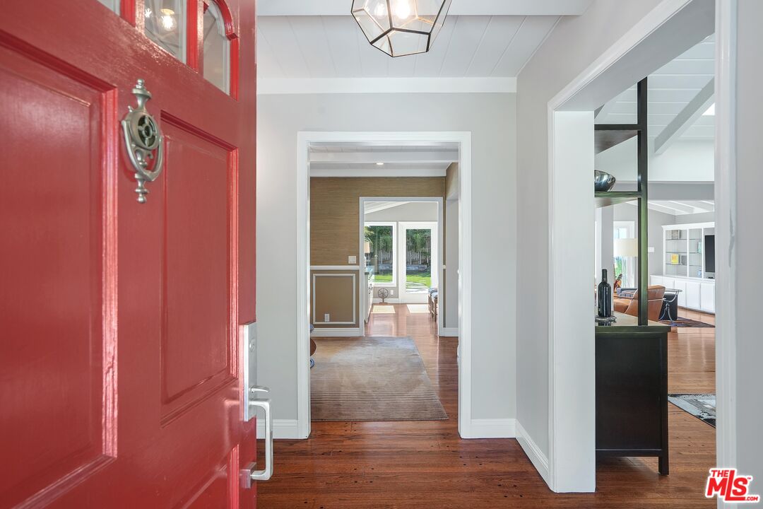 16722 Adlon Road Encino, CA 91436 - Photo 3 of 36 a view of a hallway with wooden floor and dining room
