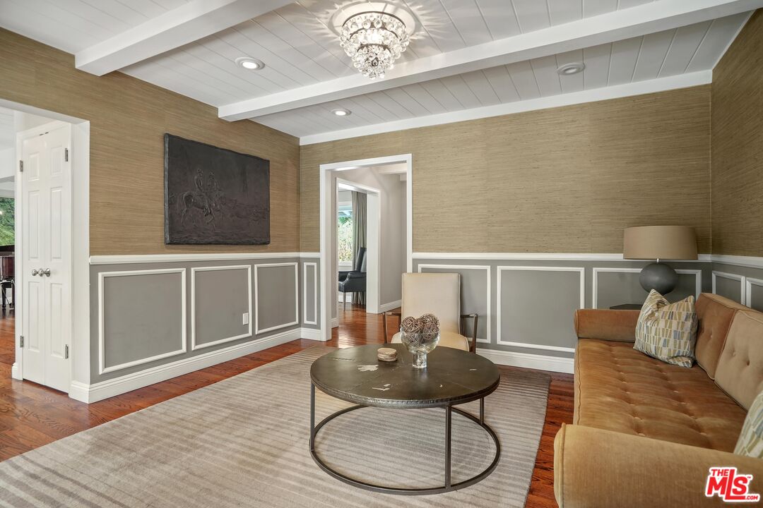 16722 Adlon Road Encino, CA 91436 - Photo 7 of 36 a living room with furniture a desk and chair with wooden floor