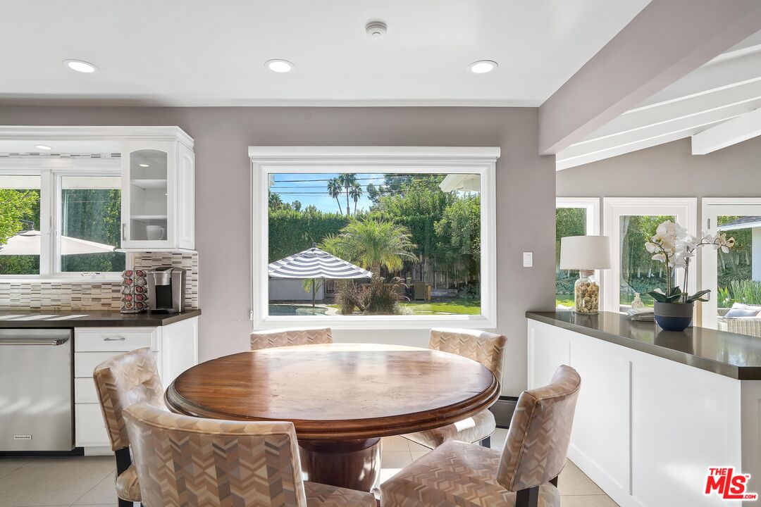 16722 Adlon Road Encino, CA 91436 - Photo 10 of 36 a dining room with furniture a window and a chandelier