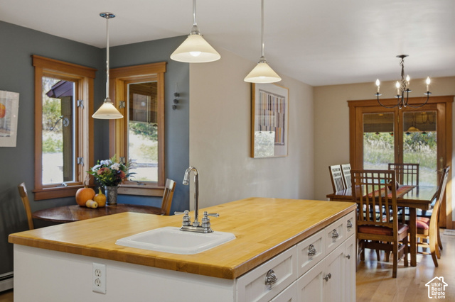 725 Canyon Road Smithfield, UT 84335 - Photo 27 of 100 Kitchen island featuring a wood-finish countertop and an integrated sink