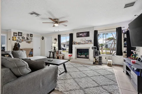 a living room with furniture large window and a fireplace