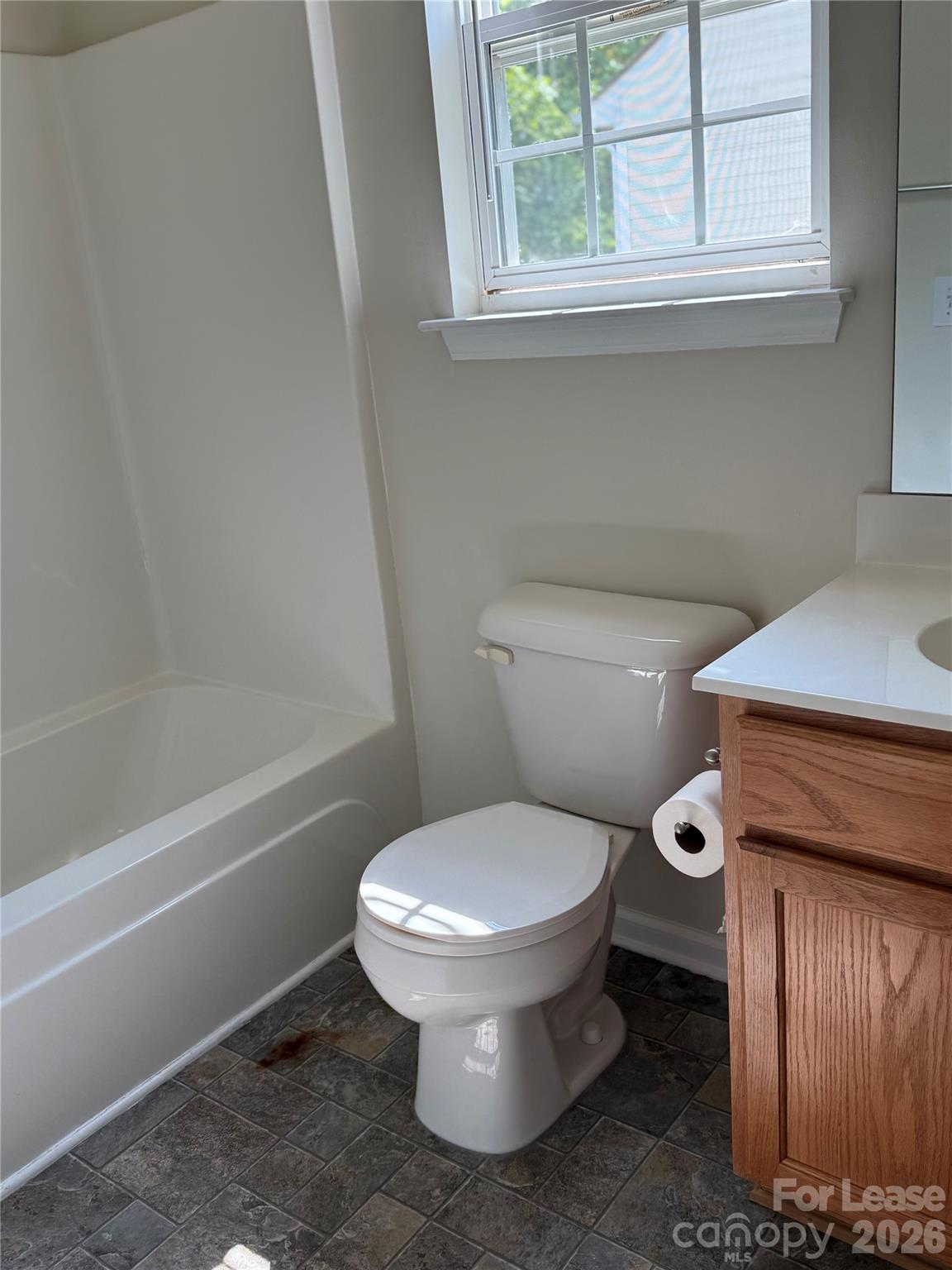 3329 Nevin Brook Road Charlotte, NC 28269 - Photo 11 of 13 a white toilet sitting next to a window