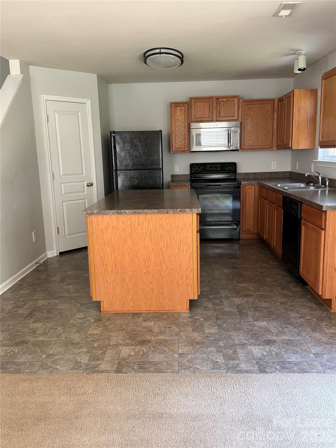 3329 Nevin Brook Road Charlotte, NC 28269 - Photo 4 of 13 a kitchen with stainless steel appliances granite countertop a stove a sink and a microwave