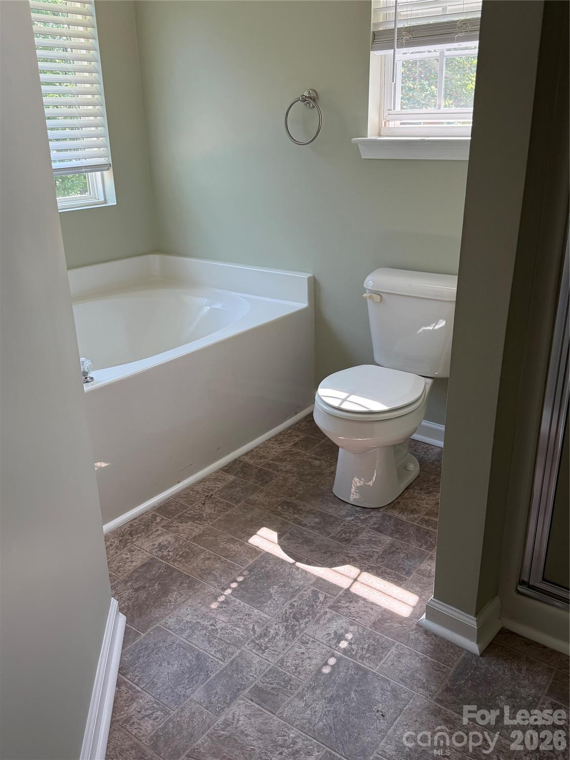 3329 Nevin Brook Road Charlotte, NC 28269 - Photo 9 of 13 a bathroom with a toilet and a bathtub