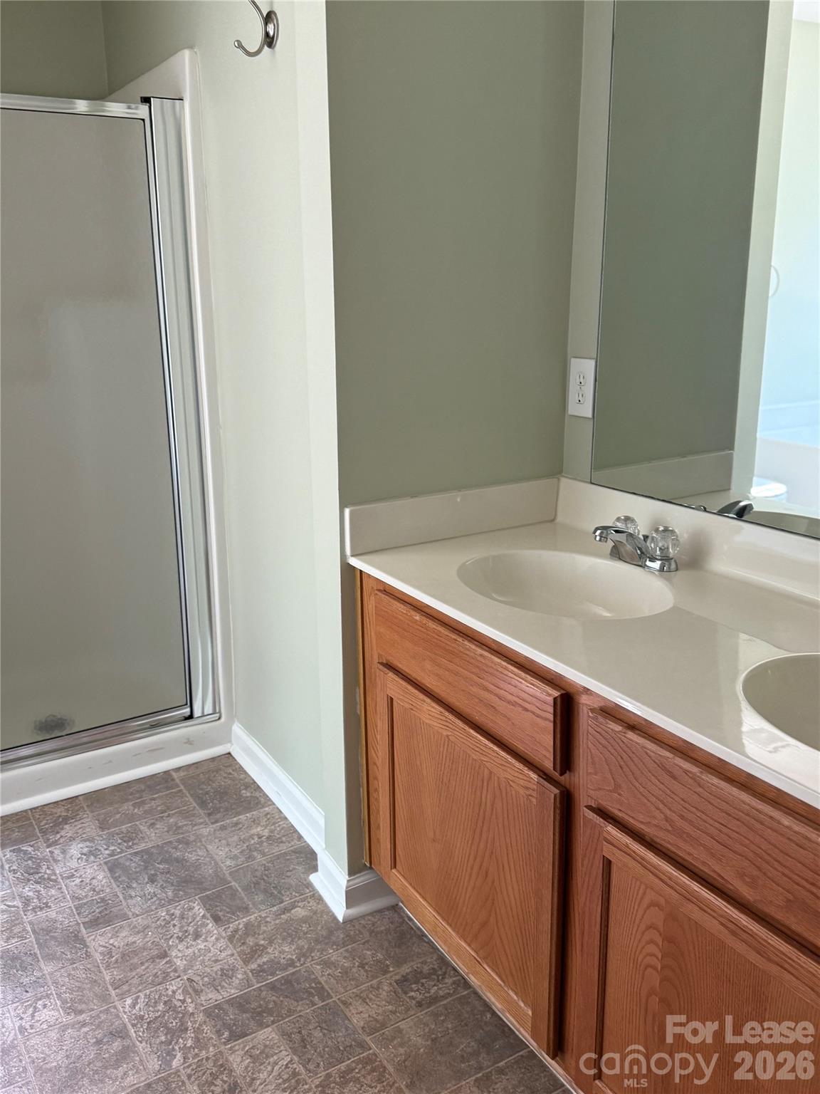 3329 Nevin Brook Road Charlotte, NC 28269 - Photo 10 of 13 a bathroom with a sink and a mirror