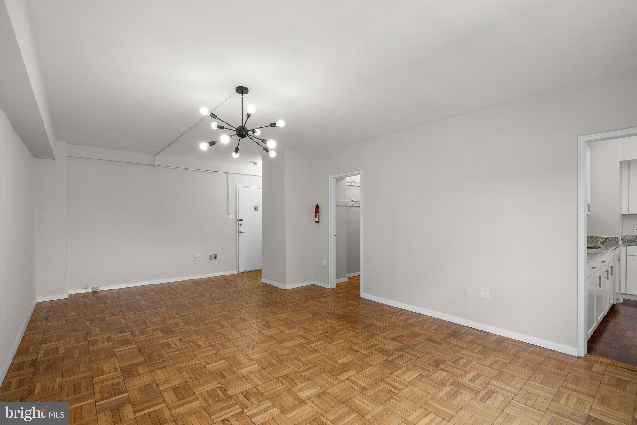 3601 Wisconsin Avenue Northwest, Unit 408 Washington, DC 20016 - Photo 12 of 17 a view of a chandelier in an empty room